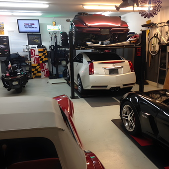 Organized garage with car lift, neon signs, and bikes - Joseph from St. Augustine, FL