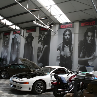 Spacious garage with cars, motorcycle, and Pirelli wall art - Mariah from Spring, TX