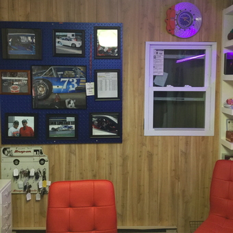 Racing Decor Wall with Red Chairs and Tools - Pat's Auto Center