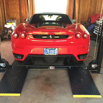 Red Ferrari on Four Post Lift in Organized Garage - DAVID IVLER from Miami, FL