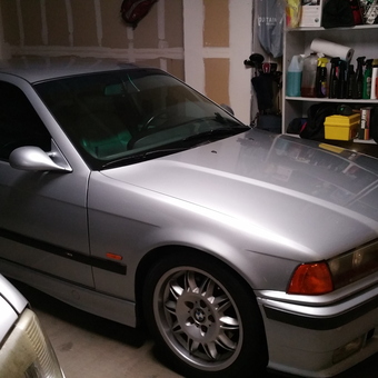 Organized garage with silver BMW and storage shelves - MMMMMGARAGE from Scottsdale, AZ