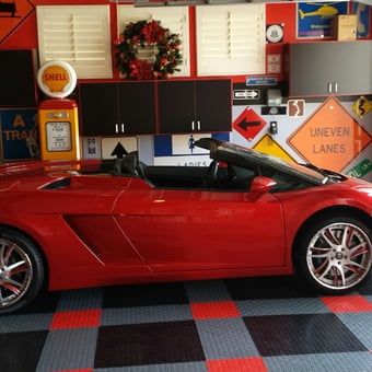 Red sports car in garage with street signs and cabinets - Pete from Yucaipa, CA