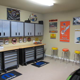 Organized Garage with Cabinets, Workbench, and Wall Decor - Bob C