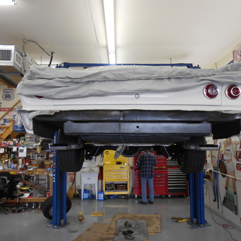 Classic car on lift with tool cabinets and wall decor - chevellejohn from Farmersville, TX