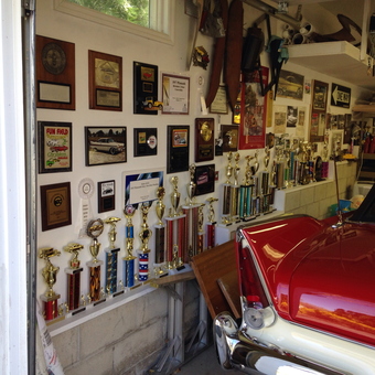 Classic Car Garage with Trophies and Wall Plaques - Anonymous