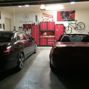 Organized garage with red cabinets, workbench, and cars - Ronnie from Boerne, TX
