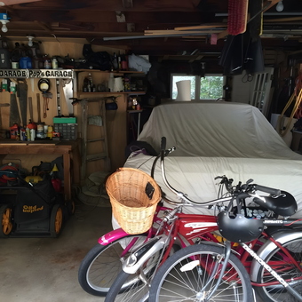 Organized garage with workbench, covered car, and bikes - Dave from Roseburg, OR