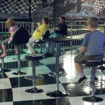 Retro Garage Bar Stools and Tables on Checkered Floor - Automobile Furniture
