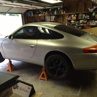 Silver sports car on jack stands in organized garage - John from Woodstock, AL