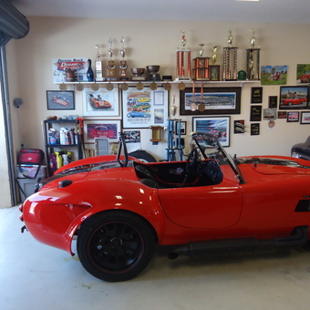 Red classic car and trophy display in organized garage - John from Daytona beach Shores, FL