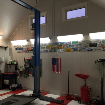 Organized garage with car lift and license plates - Geir from Norway