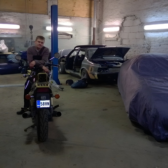 Organized garage with motorcycle, car lift, and covered vehicles - Nikita Andrejev from Tallinn
