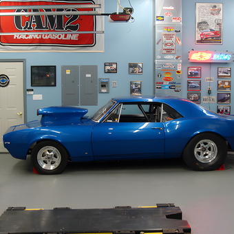 Blue muscle car with racing decor in garage - Ron from Pasadena, MD