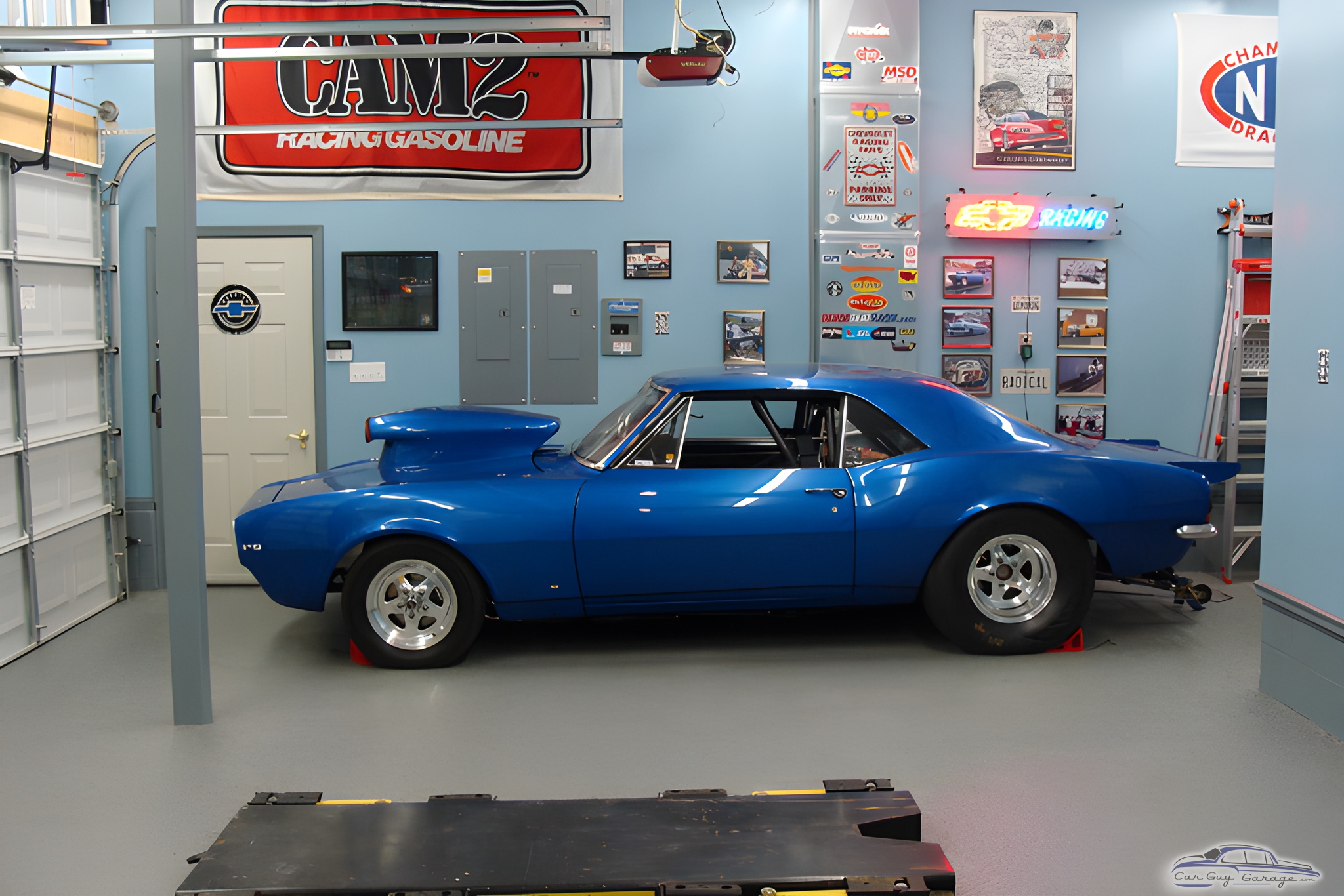 Blue muscle car with racing decor in garage - Ron from Pasadena, MD