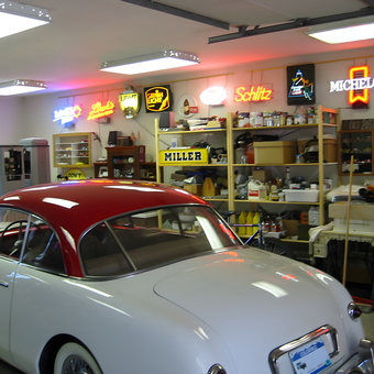 Classic car in garage with neon signs and shelving - Herb from Denver, Co