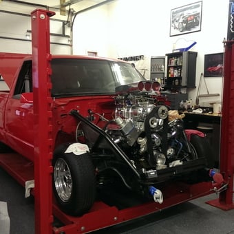 Red truck on four post lift with engine build - hush from Clarkston, MI