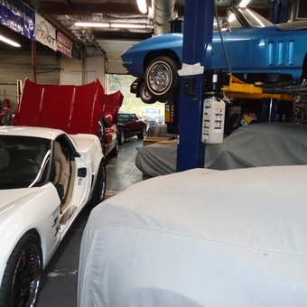 Classic and Modern Corvettes in Busy Garage - Top Flight Corvette from San Diego, Ca