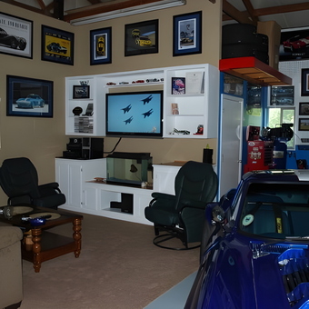 Garage lounge with car memorabilia and display wall - Be your own hero from Fall Branch, tn