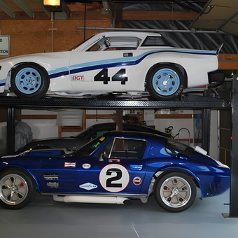 Race cars on four post lift in organized garage - Be your own hero from Fall Branch, tn