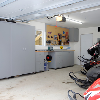 Organized garage with cabinets, workbench, and snowmobiles - Ian from Denver, CO