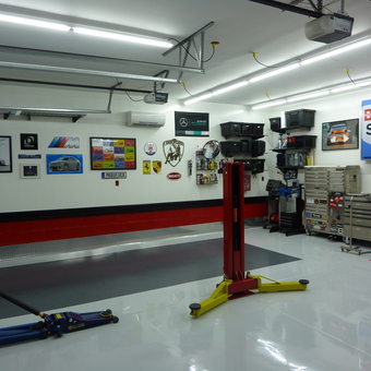 Organized garage with tool chests, car lift, and wall decor - Chris from Fort Mill, SC