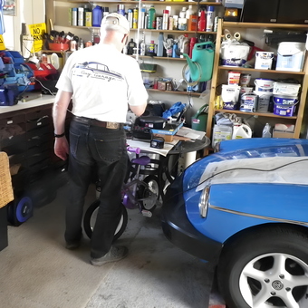 Organized garage with workbench, shelving, and blue car - Robin from Scotland