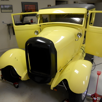 Classic yellow hot rod on car dollies in garage - Gary Carlson from Williamsburg, VA