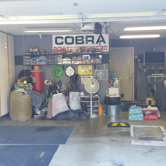 Organized garage with tool chests, cabinets, and wall decor - Warren Grant from Rocklin, CA