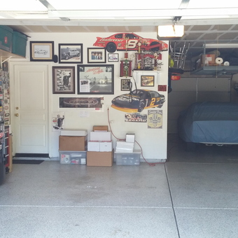 Organized garage with car, wall art, and storage - NANCY GLENSOR from ROSEVILLE, CA