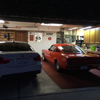 Organized garage with two cars, cabinets, and wall decor - Kris from Roseville, California