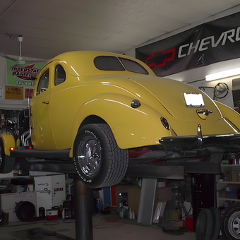 Classic Yellow Coupe on Lift in Organized Garage - Johnny Ringo from Hafford, Sask.