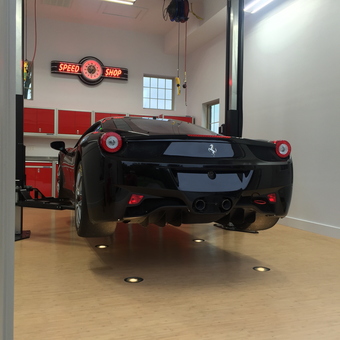Luxury garage with car lift, red cabinets, and neon sign - Joe from Crestview Hills, Kentucky