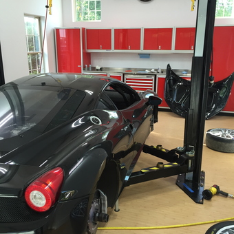 Modern garage with car lift, red cabinets, and neon clock - Joe from Crestview Hills, Kentucky