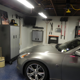 Organized garage with cabinets, wall storage, and sports car - Steve from Katy, TX