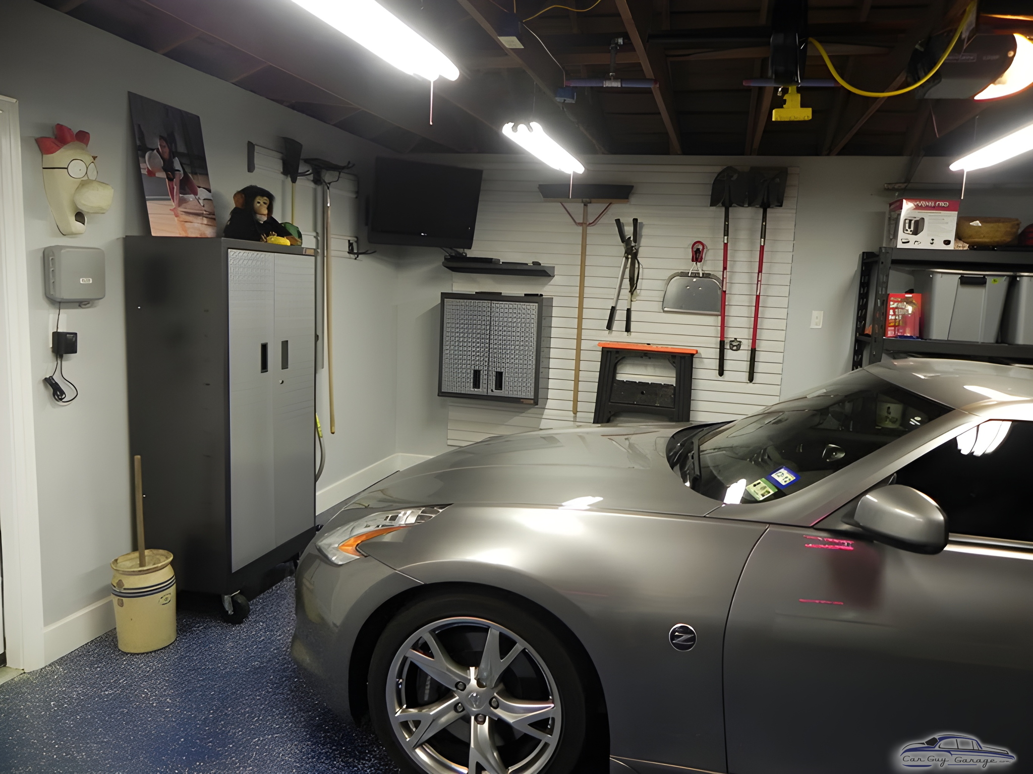 Organized garage with cabinets, wall storage, and sports car - Steve from Katy, TX