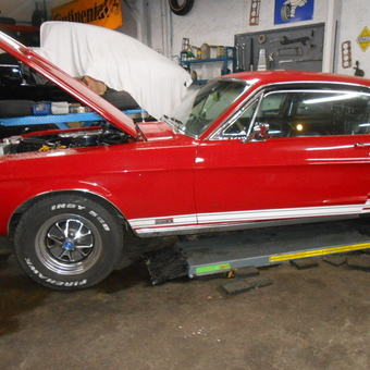 Classic red Mustang on garage lift with tools - raymond quuillet from villeurbanne, Rhone-Alpes