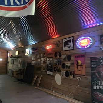 Garage Wall with Neon Signs and Car Decor - Marks MOPAR Barn from St. John's, Fla