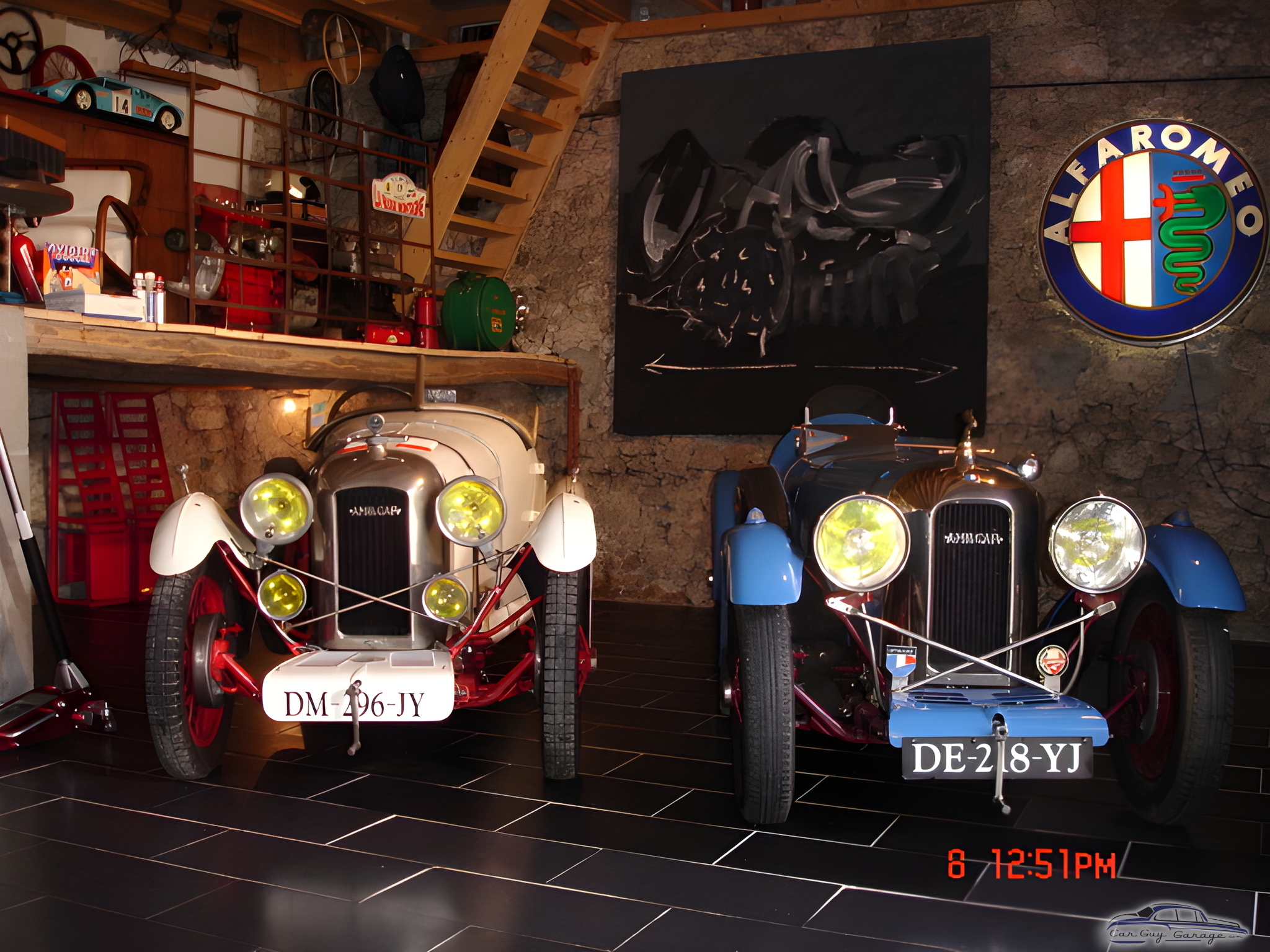 Vintage Cars in Rustic Garage with Alfa Romeo Sign - Anonymous