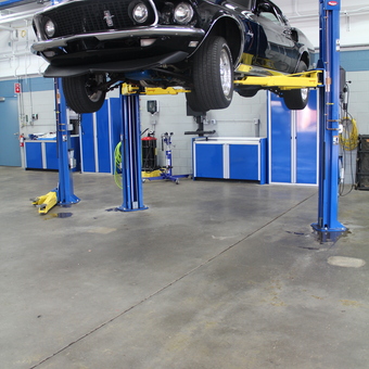 Automotive Lift and Blue Cabinets in Clean Garage - Custom Aluminum