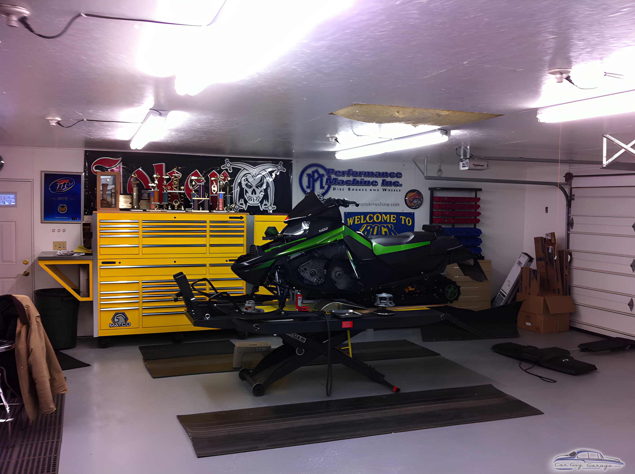 Organized garage with yellow tool chest and snowmobile lift - Larry from Weyauwega, WI