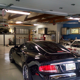 Organized garage with car lift, tool cabinets, and sports cars - Cal from Del Mar, CA