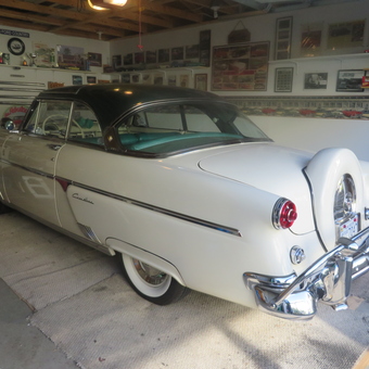 Classic car in detailed garage with trophies and decor - Bill
