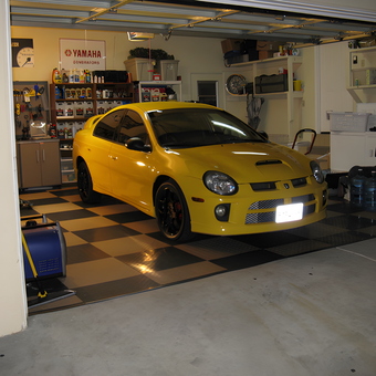 Organized garage with yellow car and storage cabinets - Josh from San Diego, CA