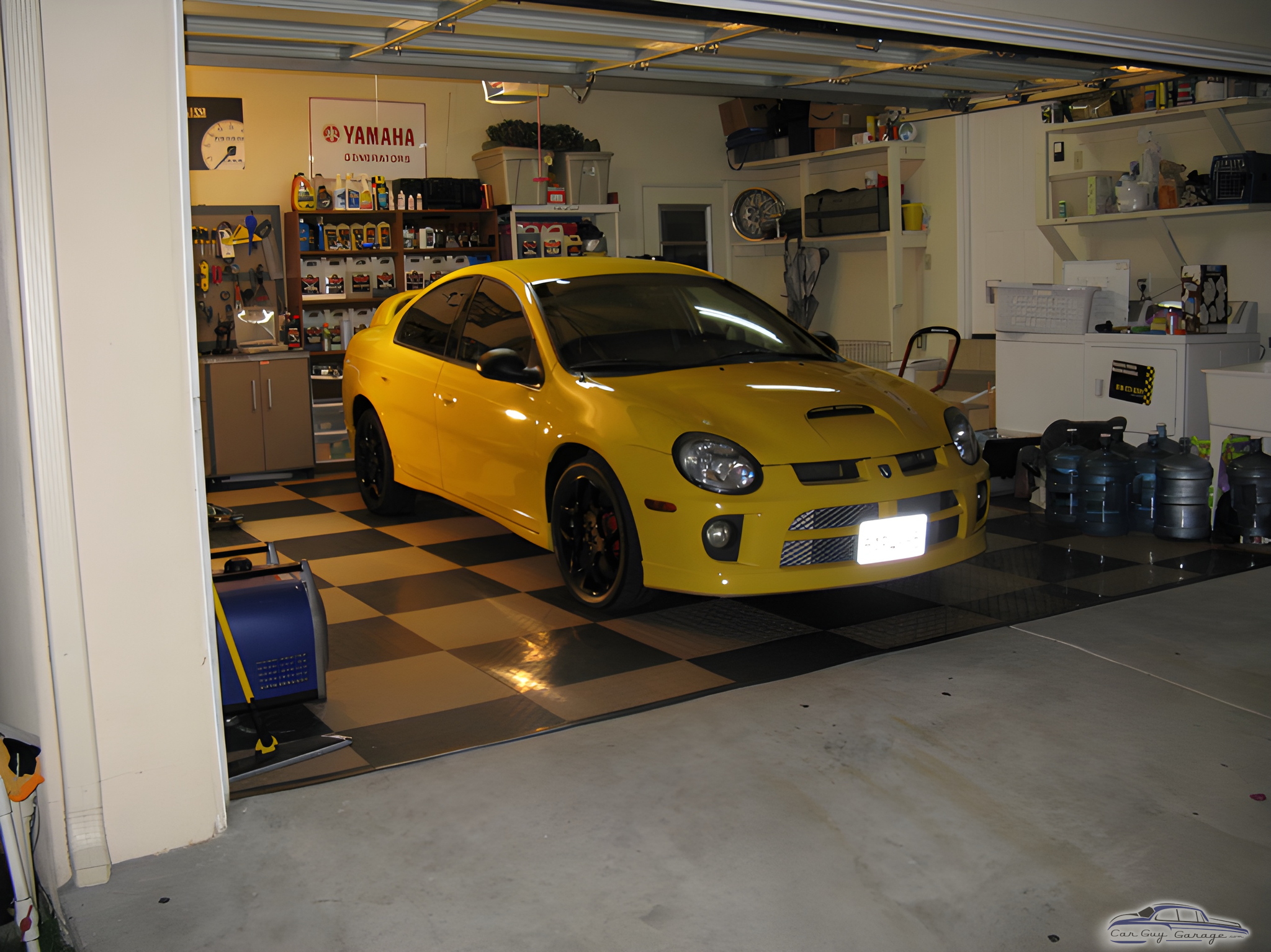 Organized garage with yellow car and storage cabinets - Josh from San Diego, CA
