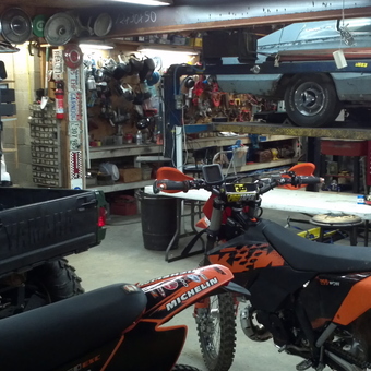 Organized garage with ATV, dirt bike, car lift, and tools - Greg Garner from Springdale, AR