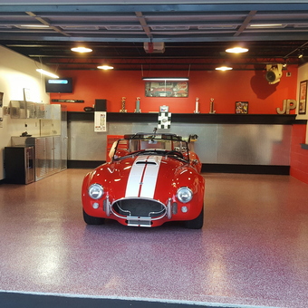 Red sports car, metal cabinets, and shelving in garage - Need4Speed from Prospect, PA