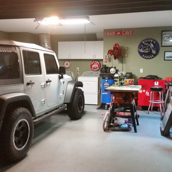 Organized garage with Jeep, tool storage, and decor - Miller's Garage from Jacksonville, Florida