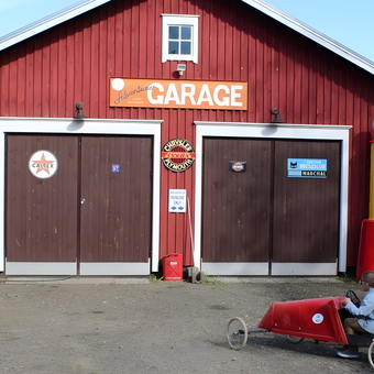 Red wooden garage with vintage gas pump and signs - Jari from Joensuu