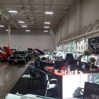 Classic Cars and Office Desks in Showroom - Streetside Classics from Charlotte, NC