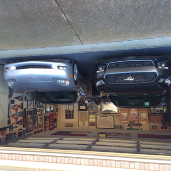 Organized garage with wall signs and two cars - David from Atoka, TN